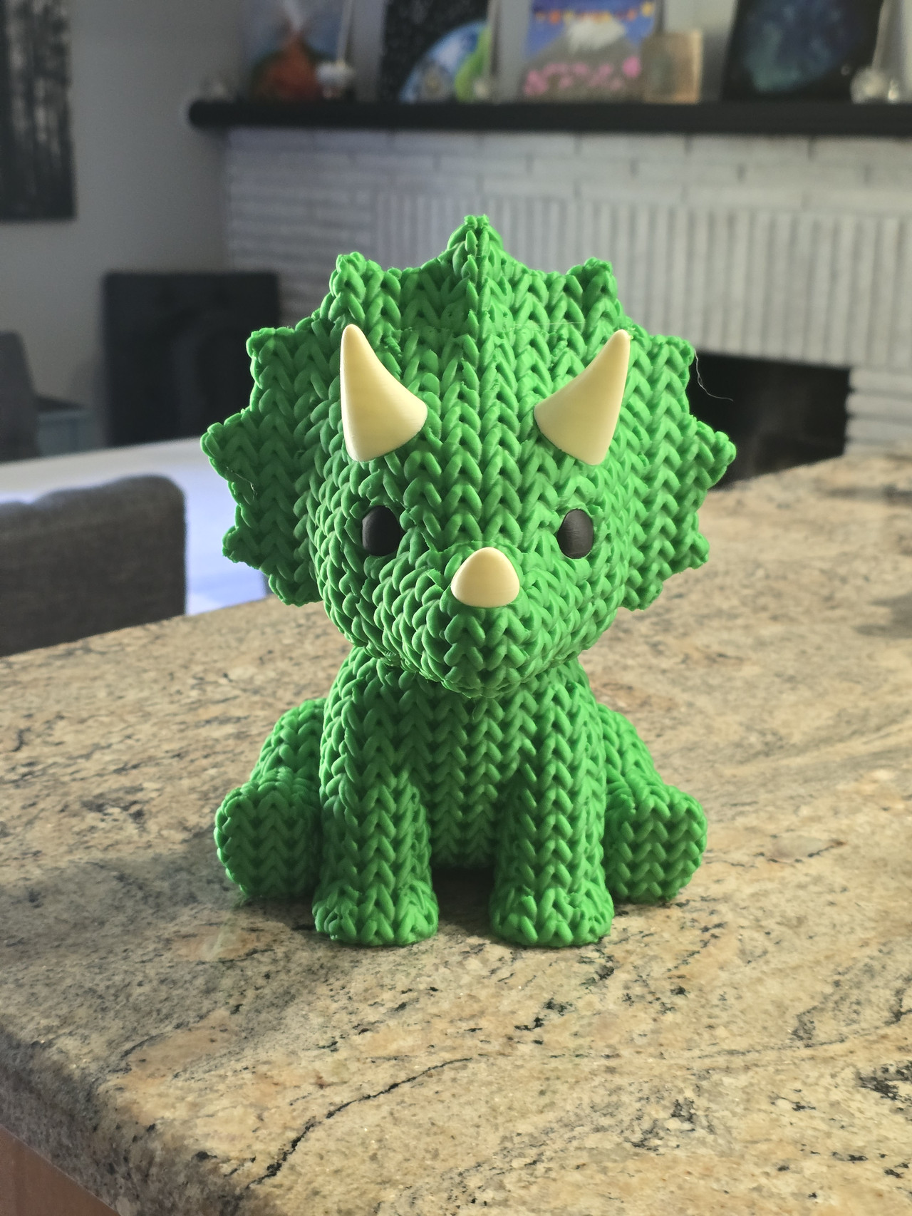 Green 3D-printed dinosaur with colorful details